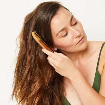 Ecomax neem wood comb with women brushing her hair