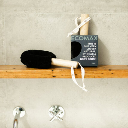 Ecomax black spa body brush and packaging on shelf in shower