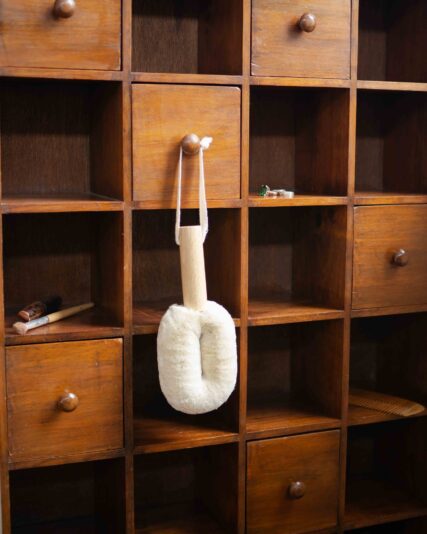 Ecomax White spa body brush hanging from draw.