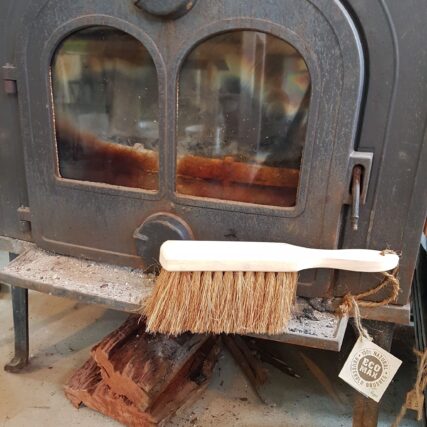 Ecomax dust brush sitting in front of fireplace