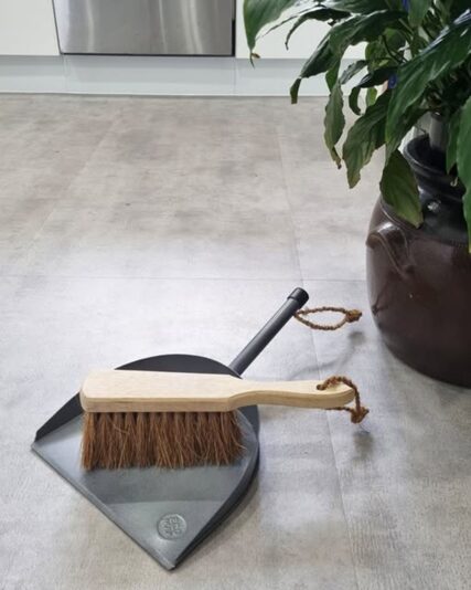 Ecomax dust brush and grey dustpan on hard floors in kitchen