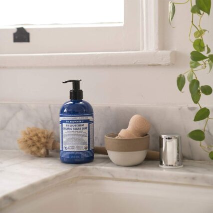 Bathroom sink with Dr. Bronner's Organic Pump Soap Peppermint next to shaving brush